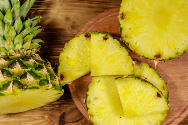 Fresh pineapple on wooden table. Top view - Foto, Imagen
