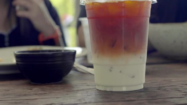 Close a cup of ice tea with human background enjoy and talking together. - Footage, Video