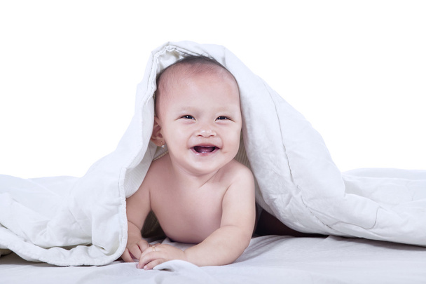 Cute baby laughing under blanket - isolated - Foto, Imagem