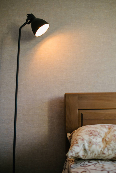 Black standing loft lamp in interior shining with edison bulb inside - Photo, Image