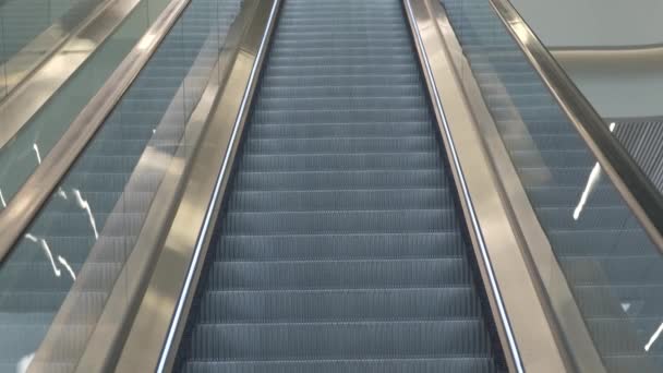 Escalator with glass railings going upstairs inside contemporary public building - Footage, Video