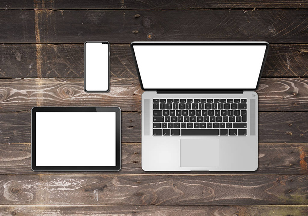 Laptop, tablet and phone set mockup on a wooden background. 3D r - Foto, Imagen