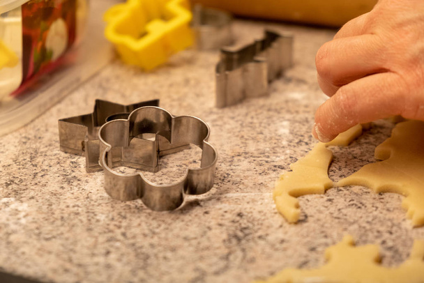 Child shaping and cutting baking cookies for christmas - Foto, imagen