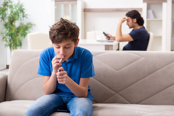 Концепция несовершеннолетнего курения с маленьким мальчиком и семьей - Фото, изображение