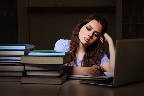 Young female student preparing for exams late at home - Photo, Image