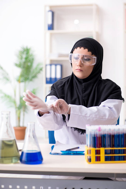 Vrouwelijke chemicus in hijab die in het lab werkt - Foto, afbeelding