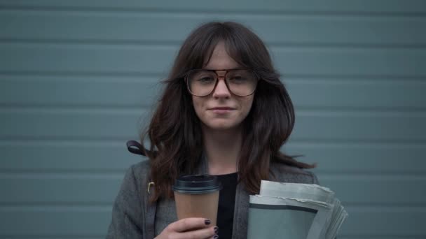 Slow motion portrait of business woman in eyeglasses with a cup of coffee - Video