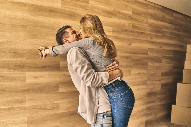 Young couple enjoying and having fun in new apartment. - Photo, image