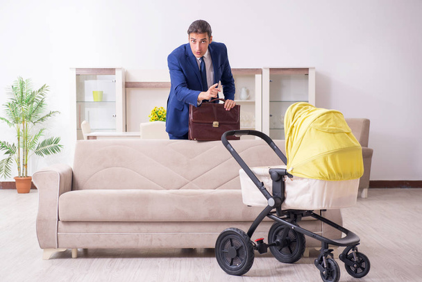 Young businessman looking after baby - Photo, Image