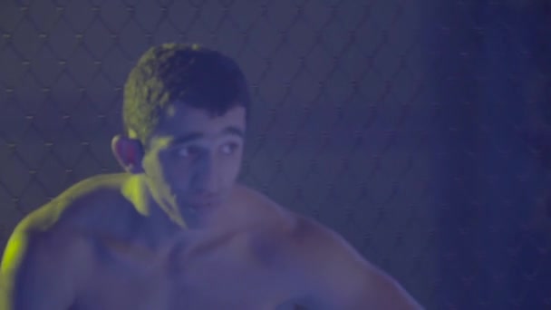 A male fighter in the MMA octagon. Slow motion. Kyiv. Ukraine - Video, Çekim
