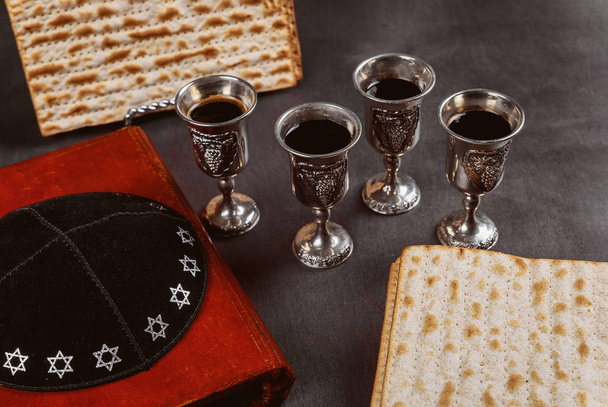 Matzoh jewish passover bread in the traditional seder plate with kipah - Photo, Image