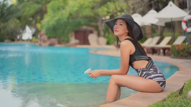 footage of beautiful Asian woman relaxing in pool at hotel - Metraje, vídeo