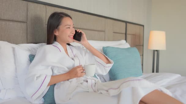 footage of beautiful Asian woman talking by phone at home - Filmmaterial, Video