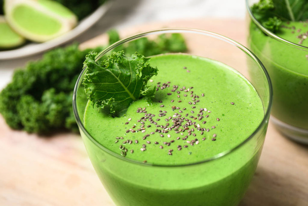 Tasty kale smoothie with chia seeds on wooden table, closeup - Fotó, kép