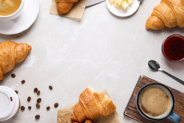 Flat lay composition with tasty croissants on light grey marble table, space for text - Fotografie, Obrázek