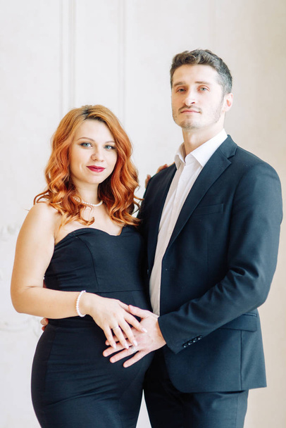  Family expecting a baby. Beautiful stylish couple in the Studio in evening images. - Fotografie, Obrázek