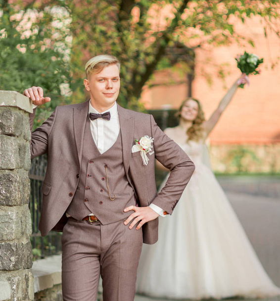 groom waiting for his bride standing on city street - Photo, image