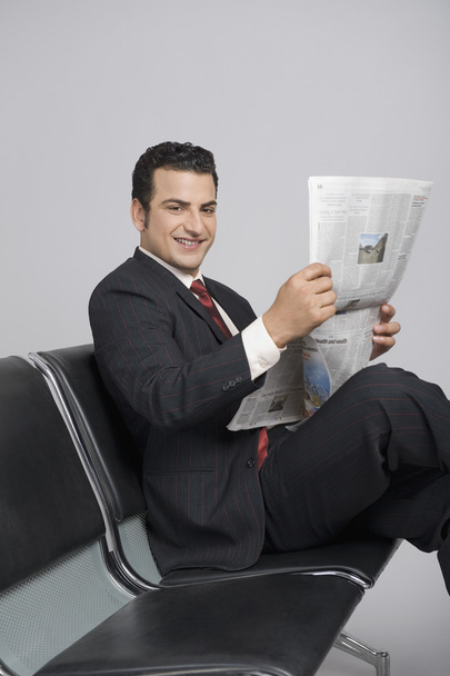 Businessman holding a newspaper - Zdjęcie, obraz