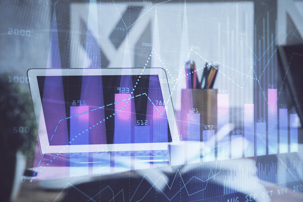 Stock market graph on background with desk and personal computer. Multi exposure. Concept of financial analysis. - Фото, зображення
