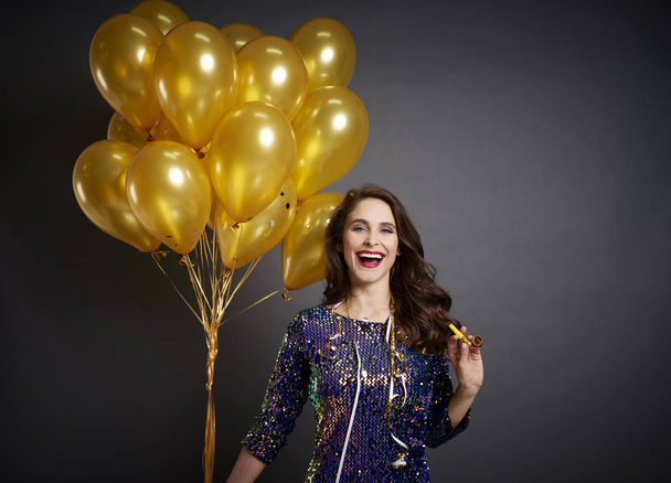 Beautiful woman with golden balloons in studio shot  - Foto, afbeelding