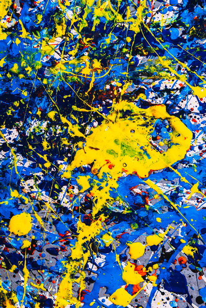 abstract expressonism. Picture painted using the technique of dripping. Mixing different colors red yellow blue white black. Vertcal orientation. - Photo, Image