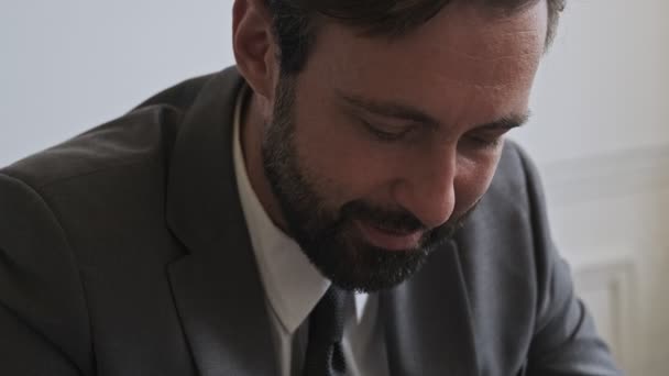 Close up view of Smiling handsome bearded businessman working at office - Filmmaterial, Video