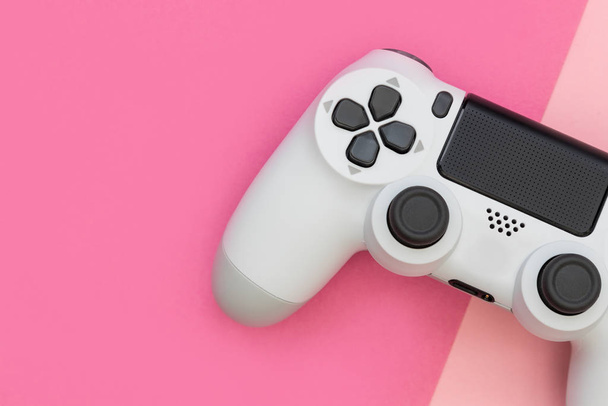 Відеоігровий ігровий контролер на фоні рожевого кольору зверху
 - Фото, зображення