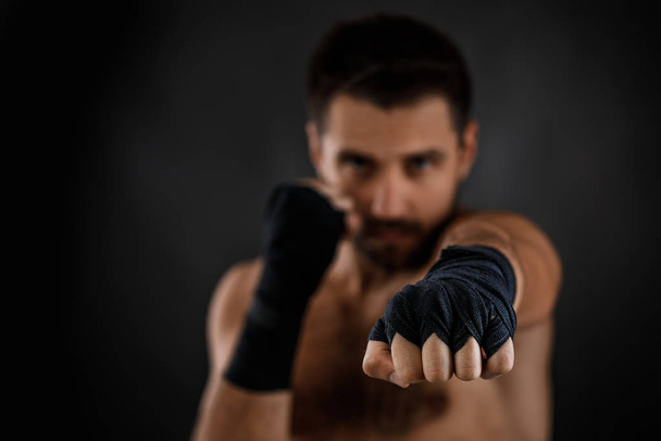 boxer man shows the different movements on black background - Foto, imagen