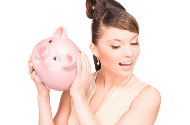 Lovely woman with piggy bank - 写真・画像