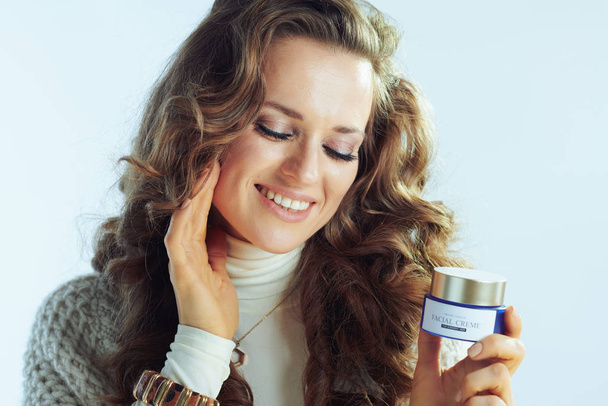 housewife with winter skin care facial creme touching face - Photo, image