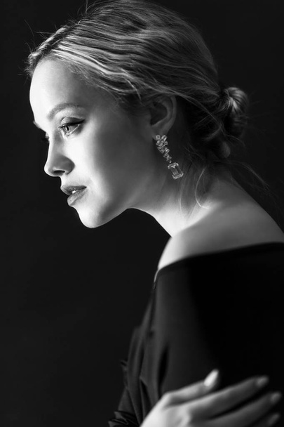 Beautiful tender blonde. Black-white portrait. Black background. - Foto, Imagen