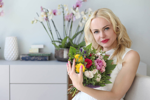 young positive girl with a bouquet of flowers - Фото, зображення