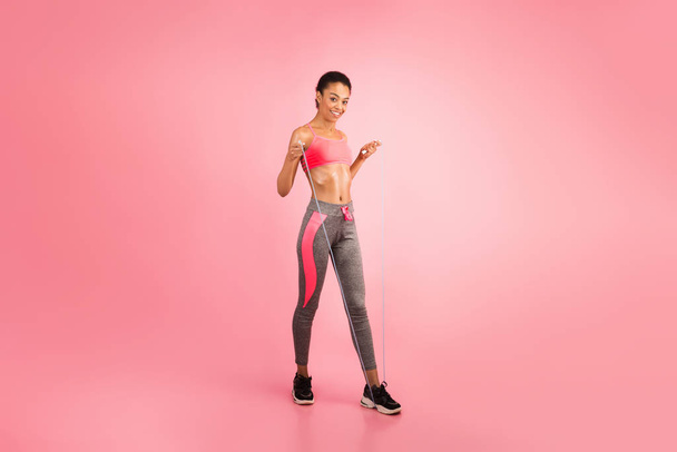 Afro Woman With Jump Rope Smiling At Camera, Pink Background - Fotó, kép