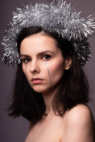 beautiful girl in a brilliant rim with rhinestones on her face - Fotoğraf, Görsel