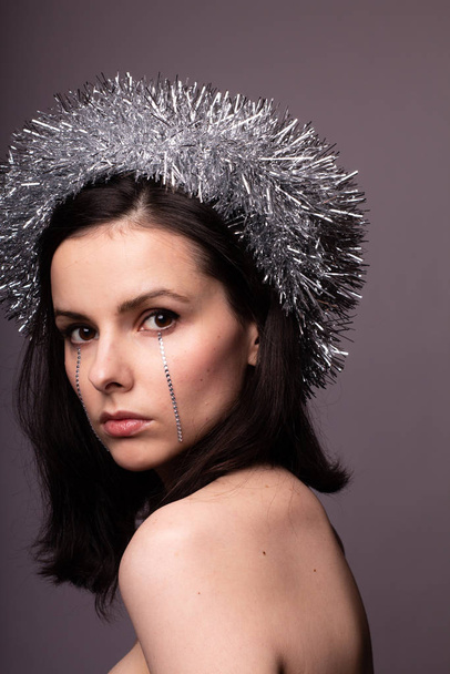 beautiful girl in a brilliant rim with rhinestones on her face - Fotografie, Obrázek