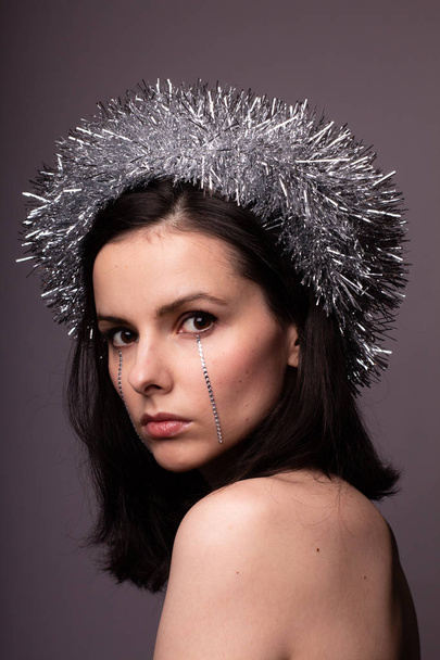 beautiful girl in a brilliant rim with rhinestones on her face - 写真・画像