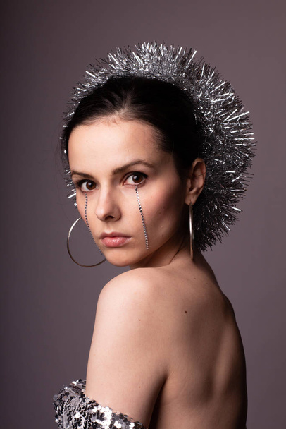 beautiful girl in a best-looking dress, a brilliant rim with rhinestones on her face - Fotografie, Obrázek