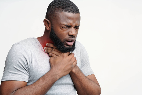 Unhealthy black guy touching neck and coughing - Photo, Image