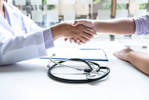 Doctor and patient shaking hands after checking with consultatio - Photo, Image