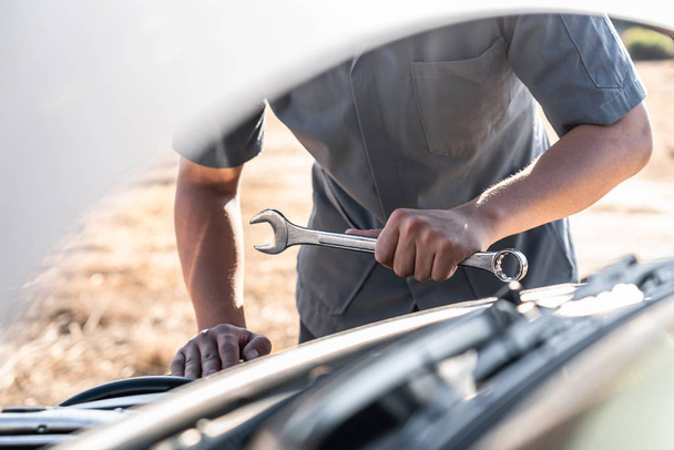 Technician hands of car mechanic in doing auto repair service an - Фото, изображение