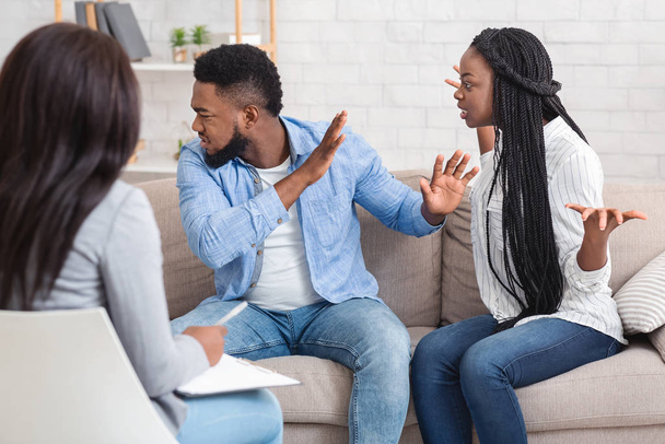 Emotional black couple quarreling at counselors office during therapy session - Photo, Image