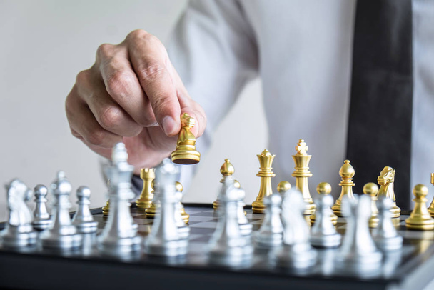 Gold and silver chess with player, Hands of businessman moving c - 写真・画像