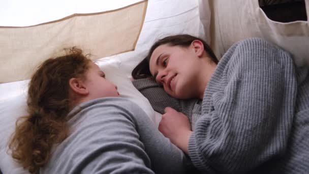 Happy family loving young mum and cute kid daughter enjoying and spend time together, laughing having fun sitting in children's room in tent at home together - Filmmaterial, Video