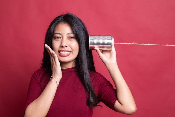 Happy Young Asian woman listen with tin can phone. - Foto, Imagen
