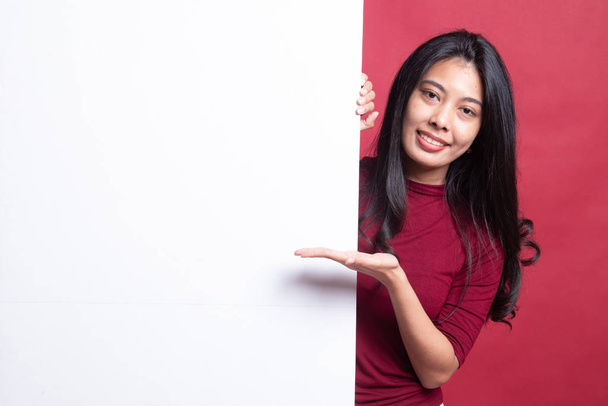 Young Asian woman present blank sign with palm hand. - Фото, изображение