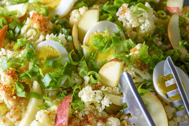 Salad with fresh ingredients and eggs ready to be served as a side dish - Photo, Image