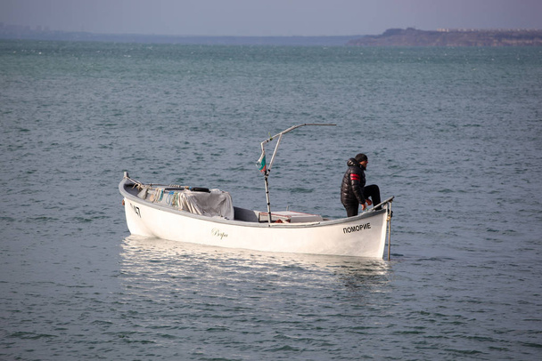 Pomorie, Bulgaria - January 06, 2020: Fisherman in the Bay of Pomorie. - Фото, изображение