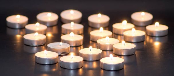 Many flaming candles - Фото, изображение