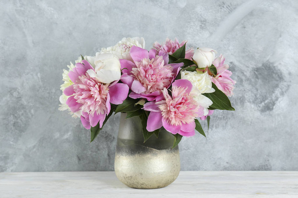 Beautiful peony flowers closeup over textured background with a lot of copy space for text. International women's mother's valentine's first spring day. Close up, top view, backdrop, flat lay. - Foto, Bild