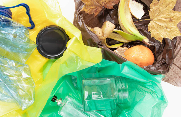 Sorting household waste into colored garbage bags. Recycling and sorting for ecology. - Photo, Image
